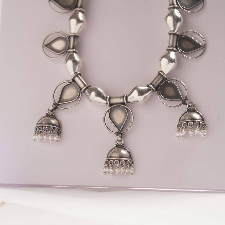 a close up of a necklace on a table