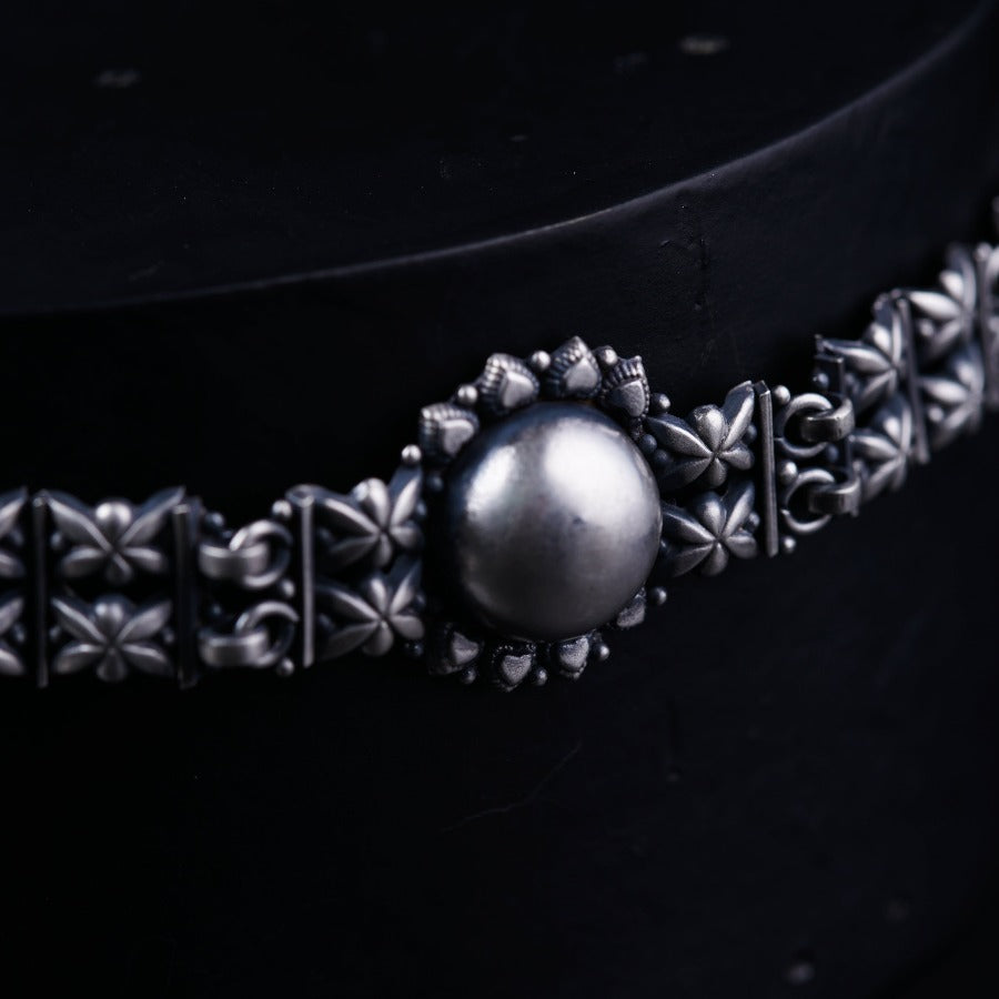 a close up of a metal object on a black surface