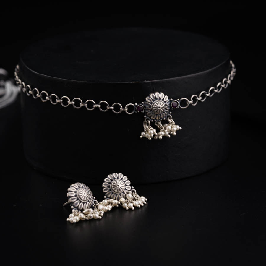 a pair of silver jewelry on a black surface