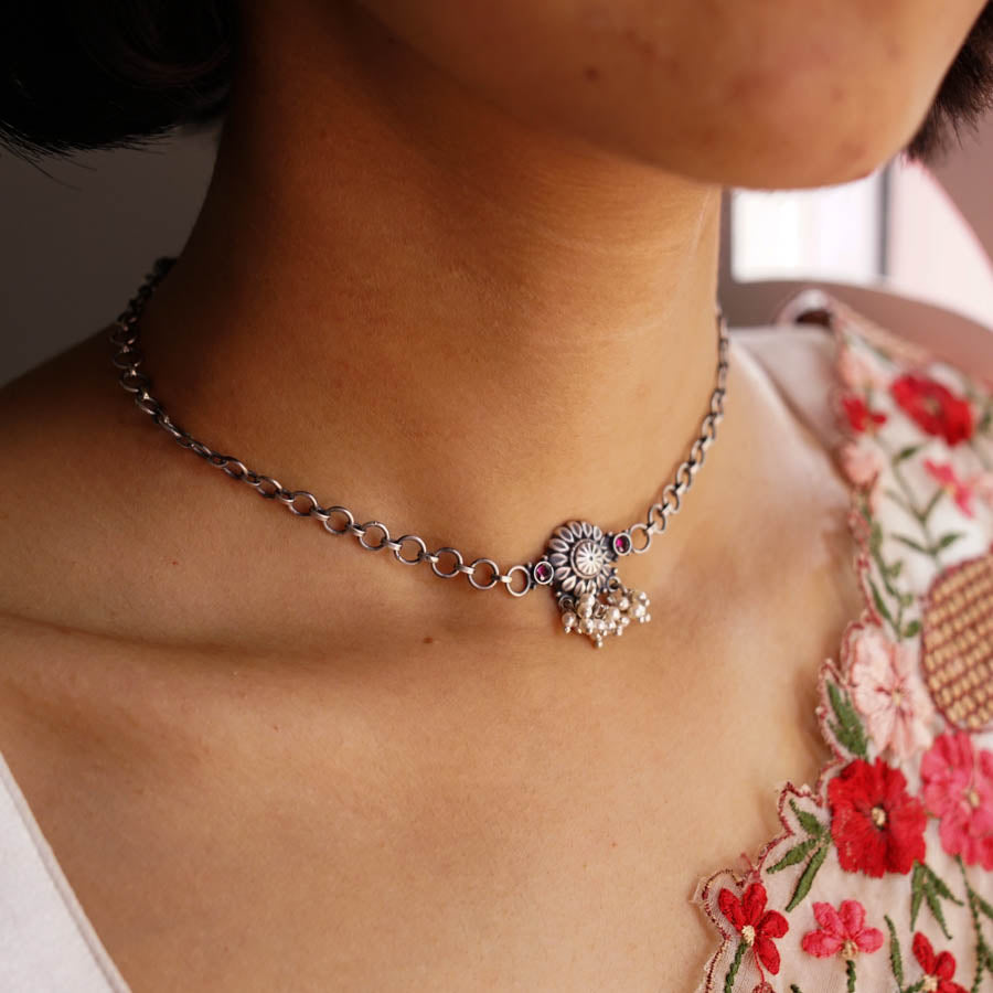 a close up of a woman wearing a necklace