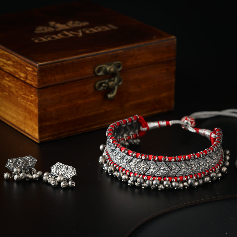 a set of silver and red beaded bracelets