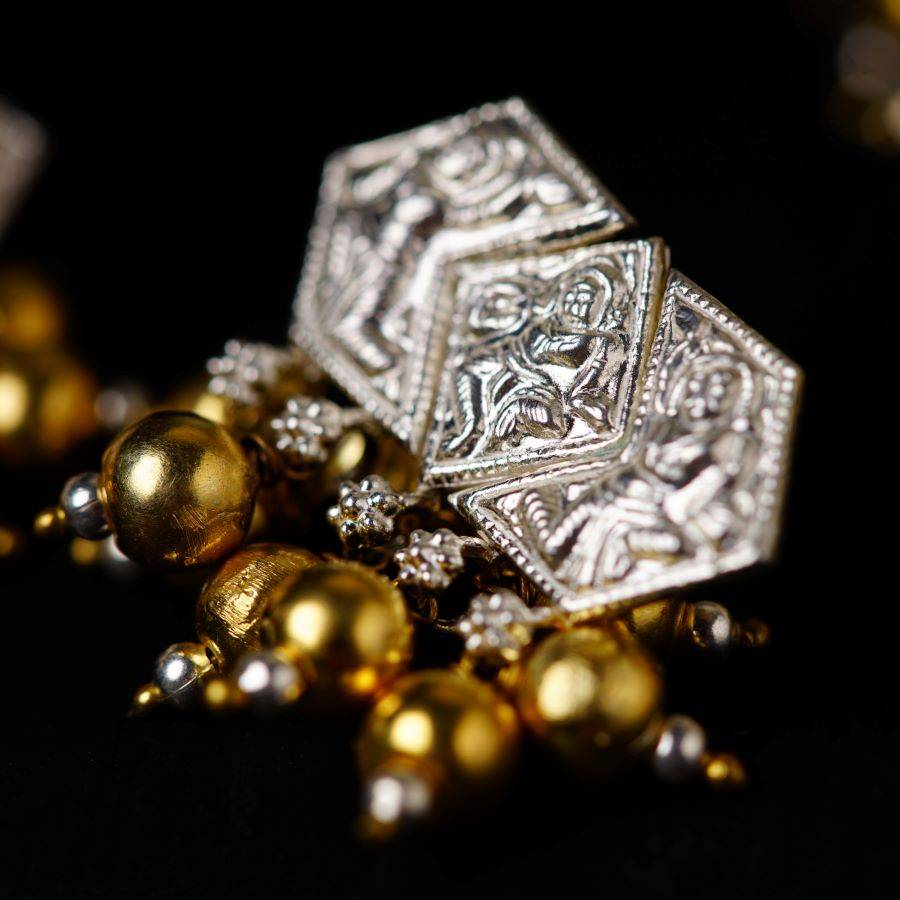 a close up of a gold and silver object
