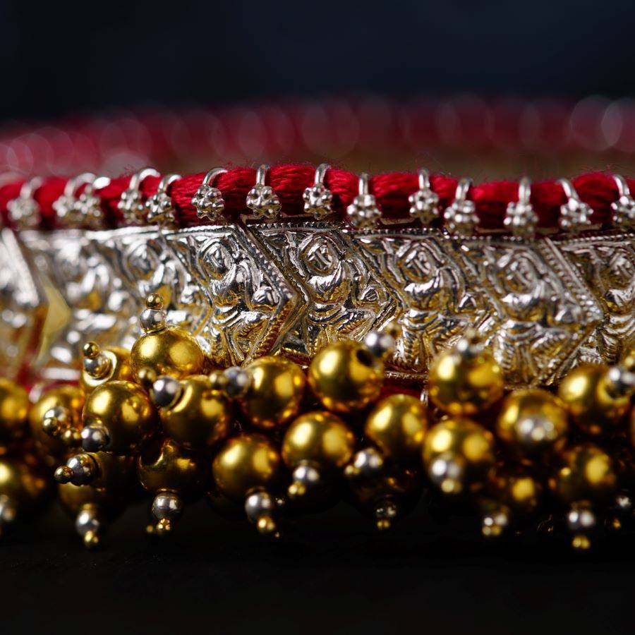 a bunch of gold and red beads on a table