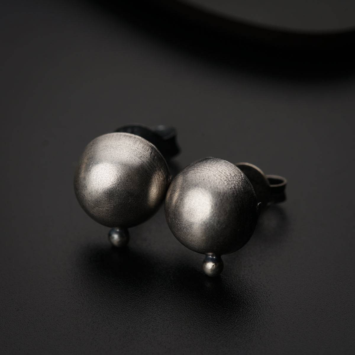 a pair of silver balls sitting on top of a table