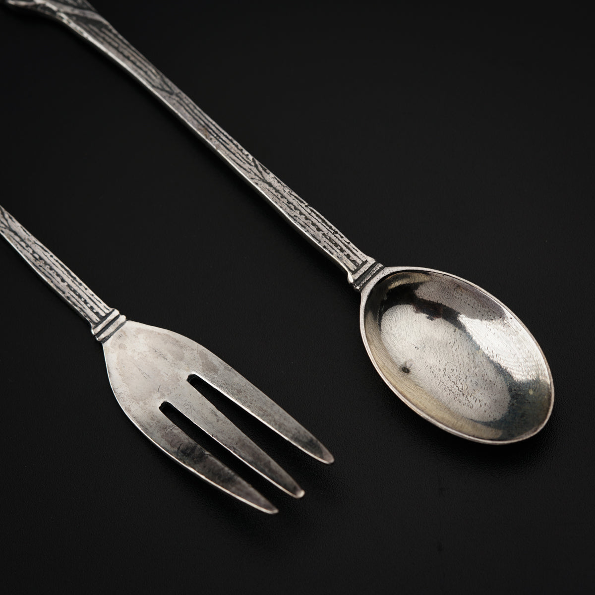 a couple of spoons and a fork on a table