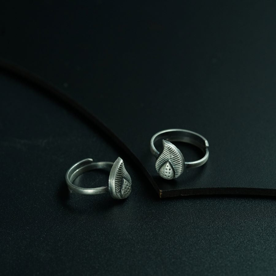 two rings sitting on top of a black surface