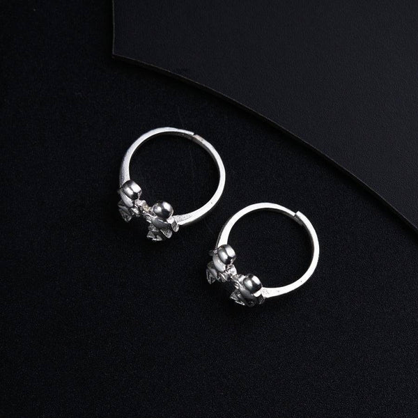 a pair of silver hoop earrings on a black background