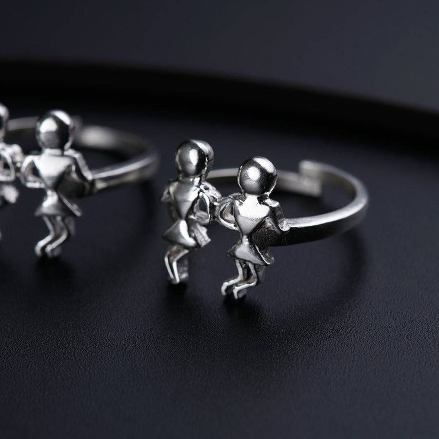 a couple of silver rings sitting on top of a table