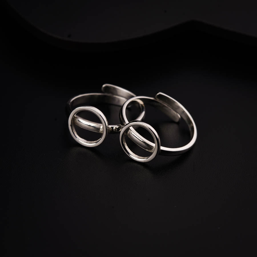a set of three rings sitting on top of a black surface