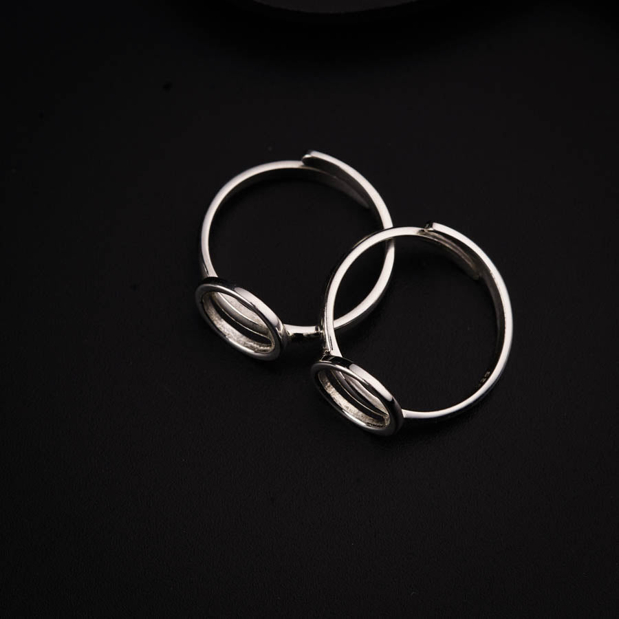 a pair of silver rings on a black surface