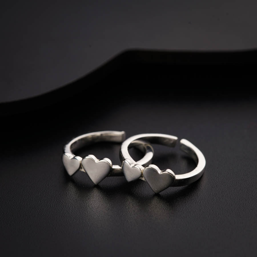 two heart shaped rings sitting on top of a table