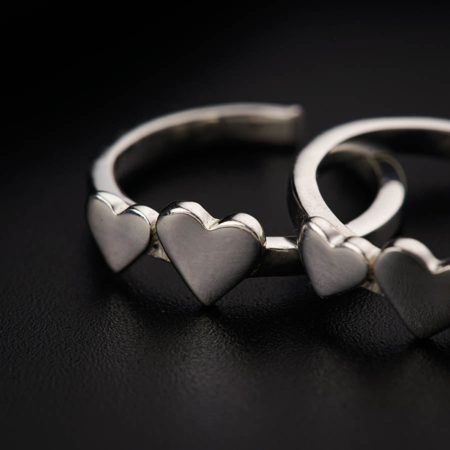 a couple of silver rings sitting on top of a table