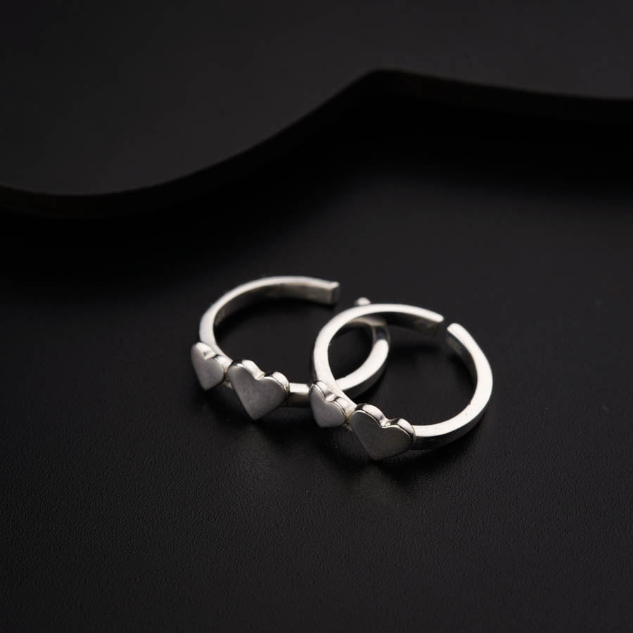a pair of silver rings on a black surface