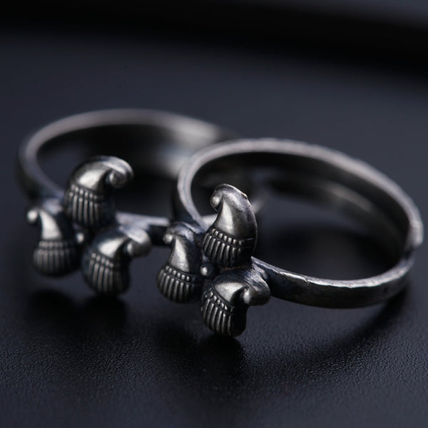 a pair of silver rings sitting on top of a table