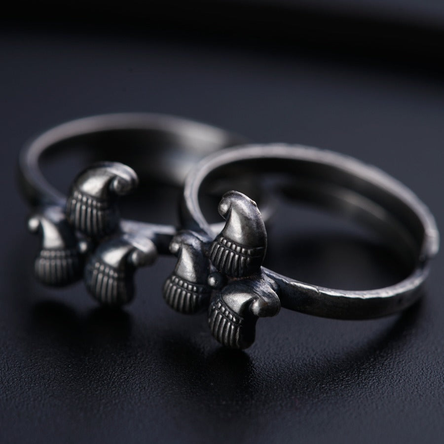a pair of silver rings sitting on top of a table