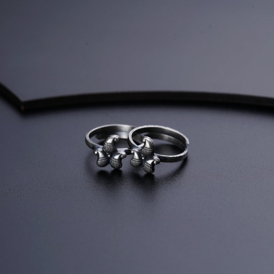 two silver rings sitting on top of a black surface