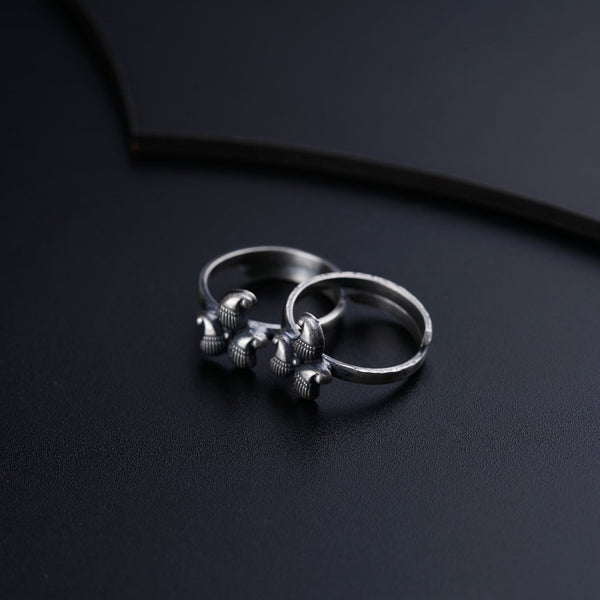 two silver rings sitting on top of a black surface