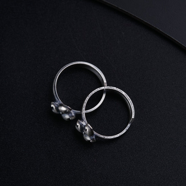 a pair of silver rings sitting on top of a table