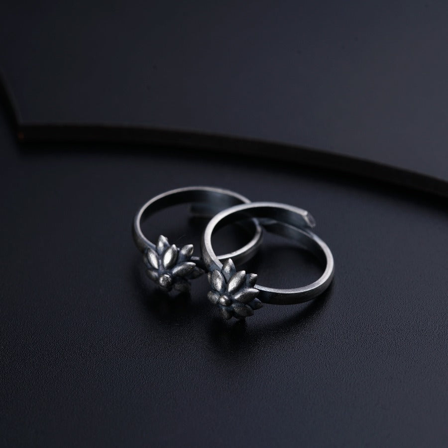 two silver rings sitting on top of a black surface