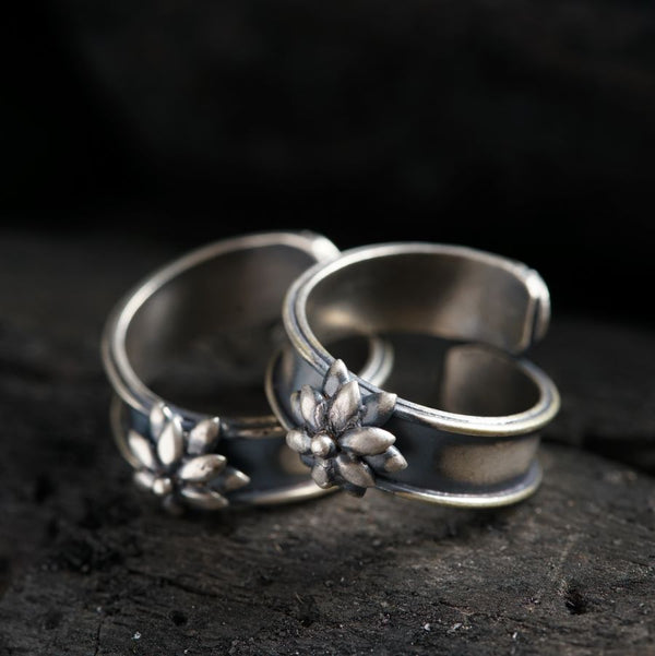 two wedding rings sitting on top of a rock