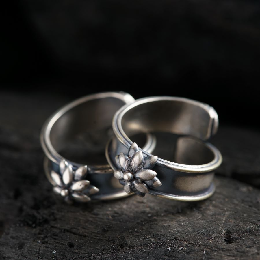 two wedding rings sitting on top of a rock