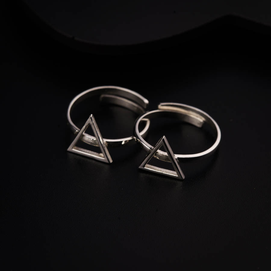two silver rings with a triangle on top of them