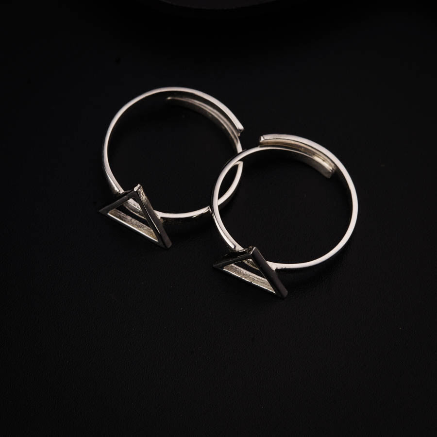 a pair of silver rings on a black surface