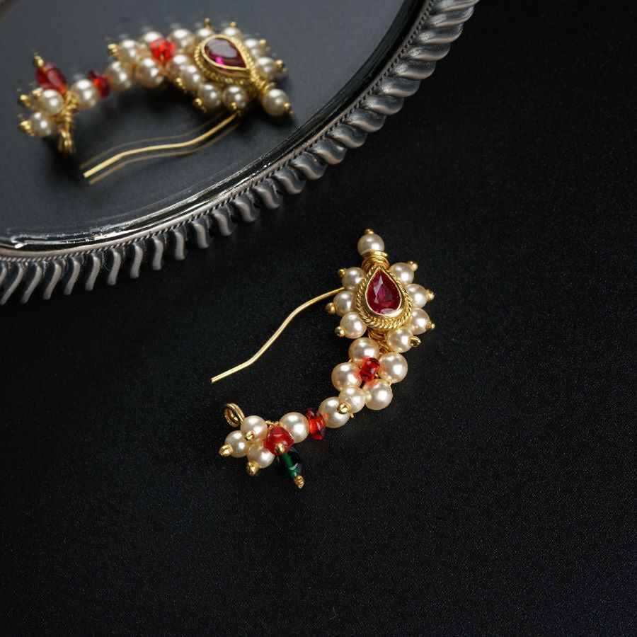 a pair of earrings sitting on top of a table