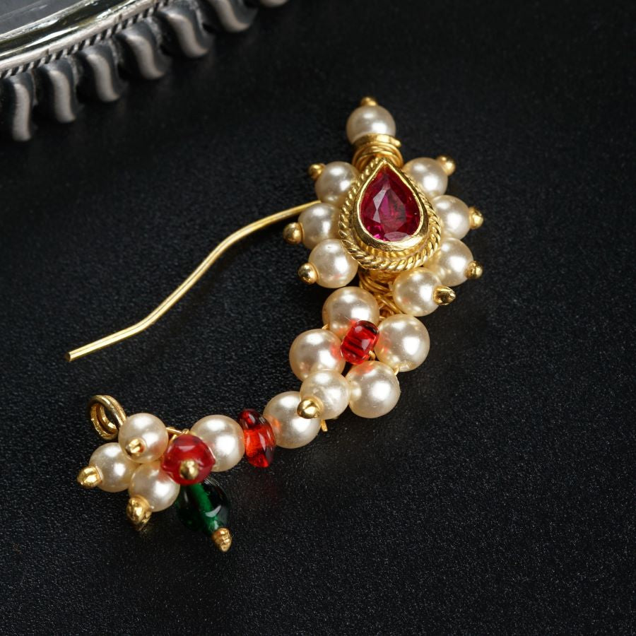 a close up of a pair of earrings on a table