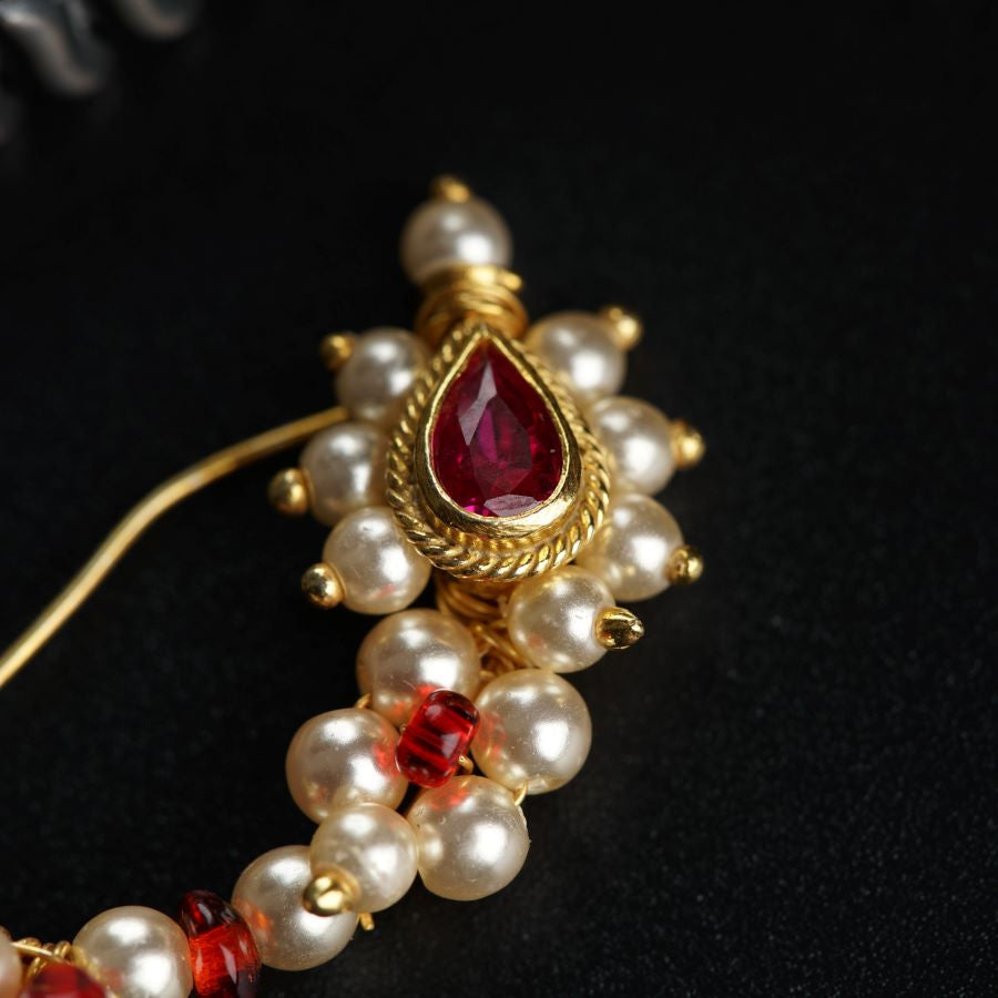 a close up of a necklace with pearls