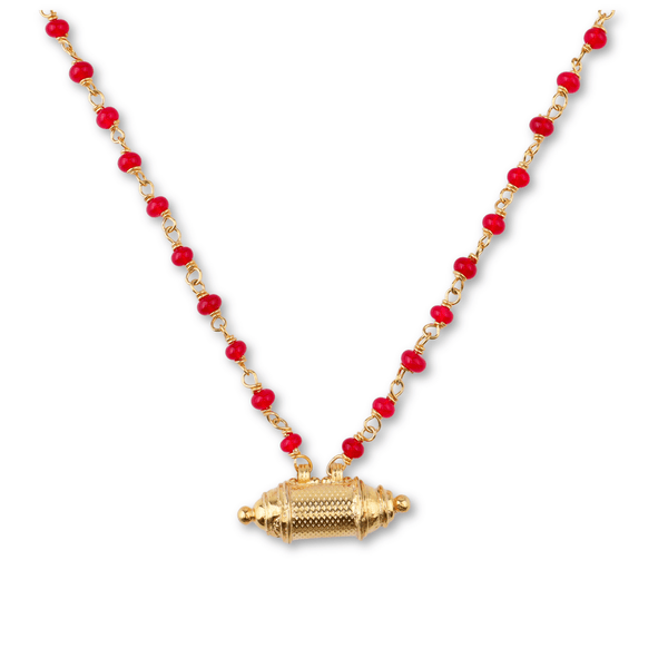 Gold necklace with red beads and intricate pendant