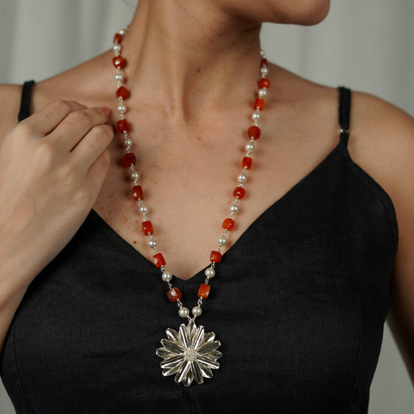 Model wearing Carnelian and Pearl beaded necklace with sunflower pendant