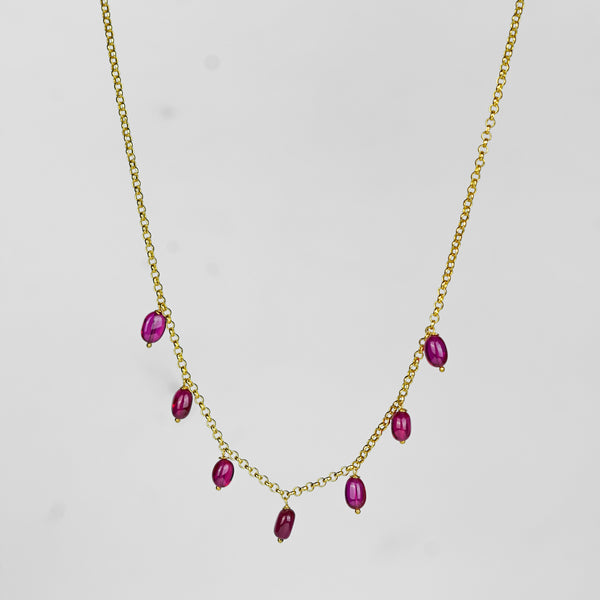 Gold chain with ruby beads close-up
