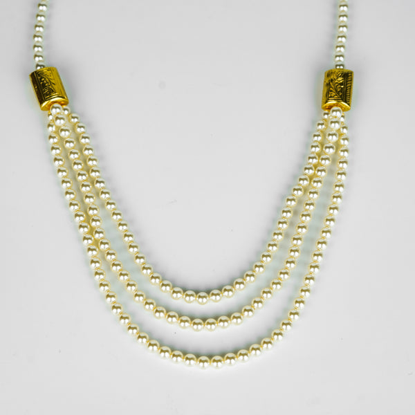 Angled side view of 3 Layer Necklace with Carved Bead and Pearls