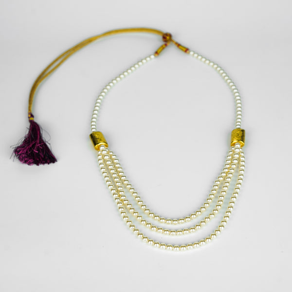 Model wearing 3 Layer Necklace with Carved Bead and Pearls