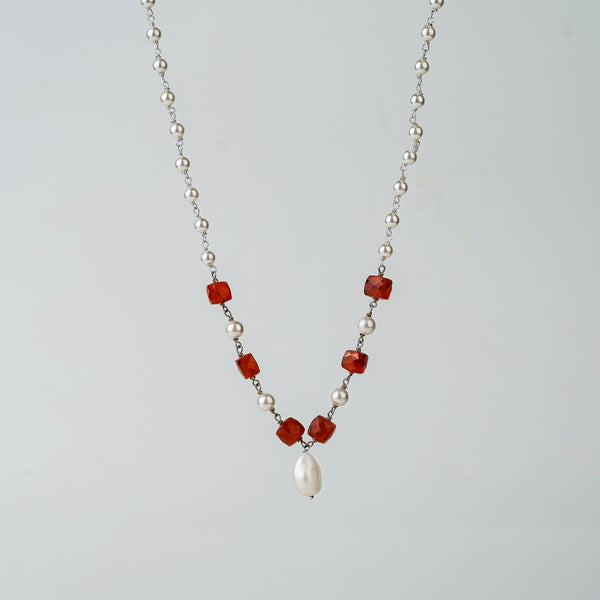 Angled side view of Pearl Ganthan Necklace with stones