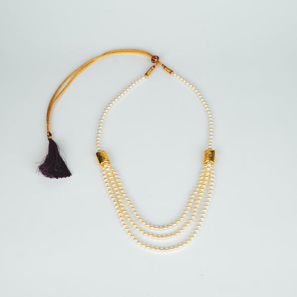 Woman styling 3 Layer Necklace with Carved Bead and Pearls