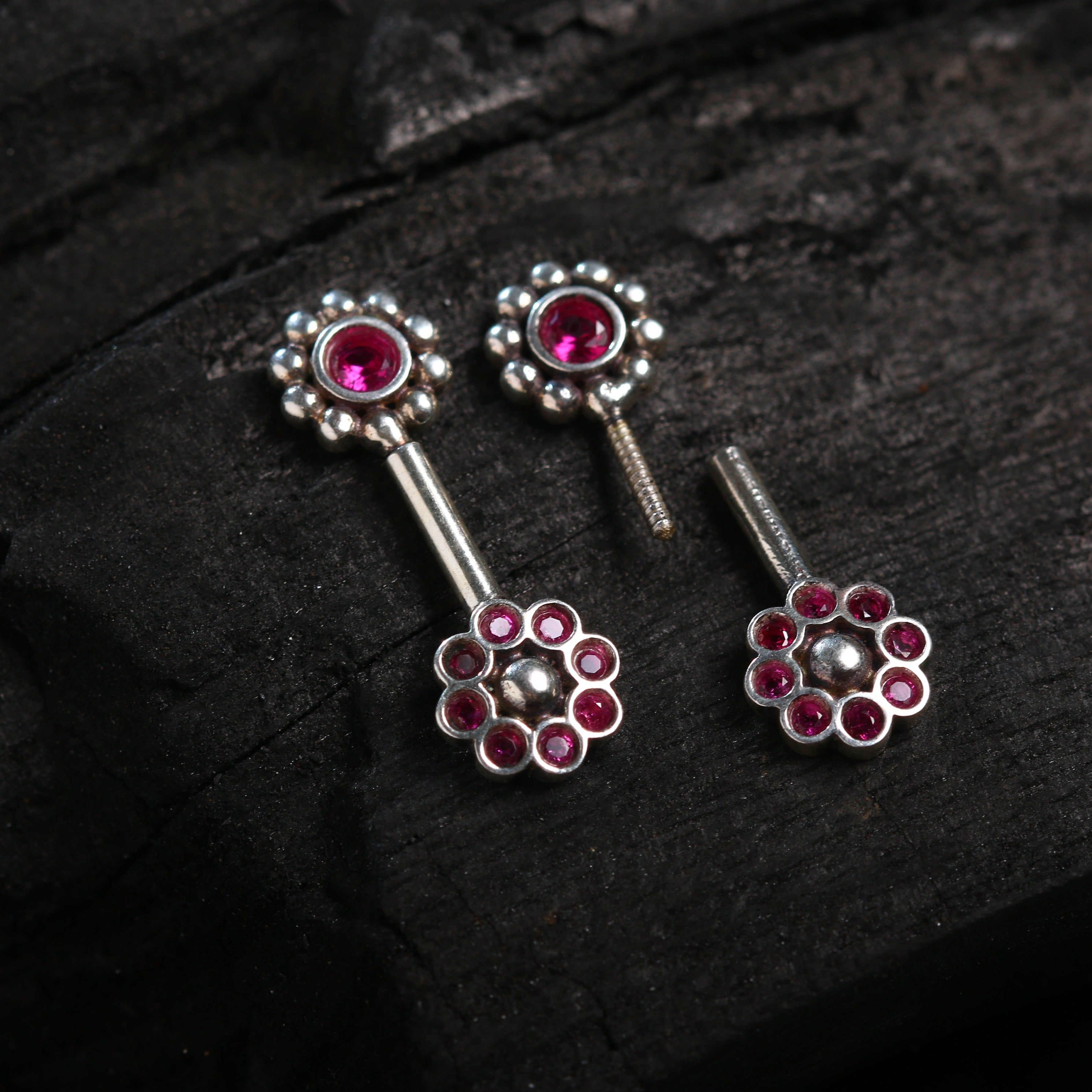 a pair of silver and pink jeweled earrings