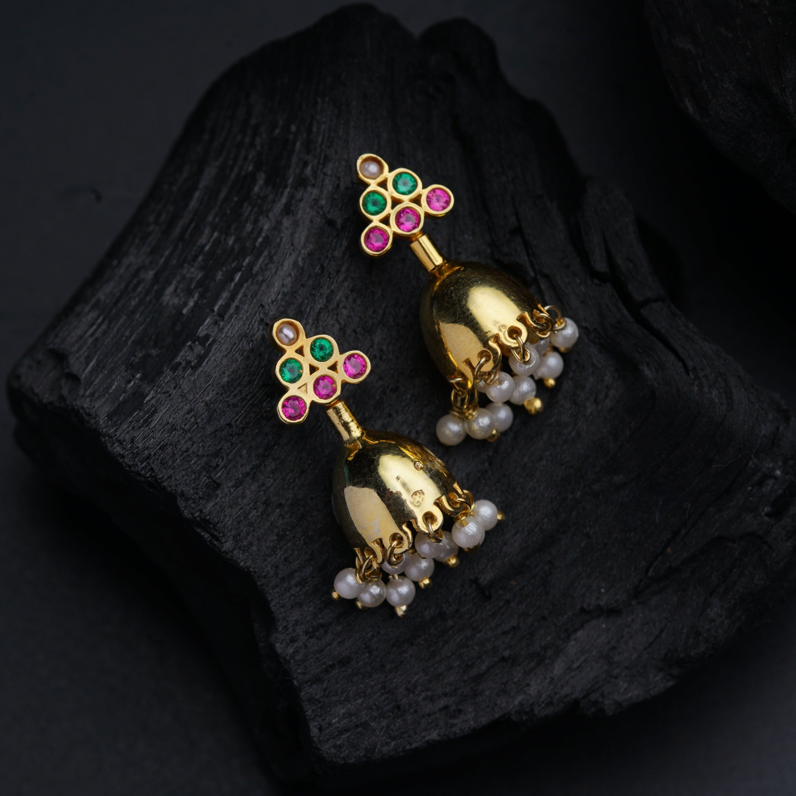a pair of gold bells with colorful stones