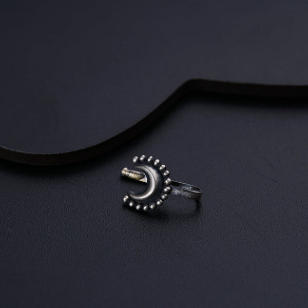 a ring sitting on top of a black surface