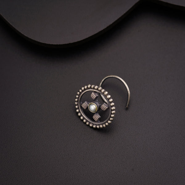 a close up of a pair of earrings on a black surface