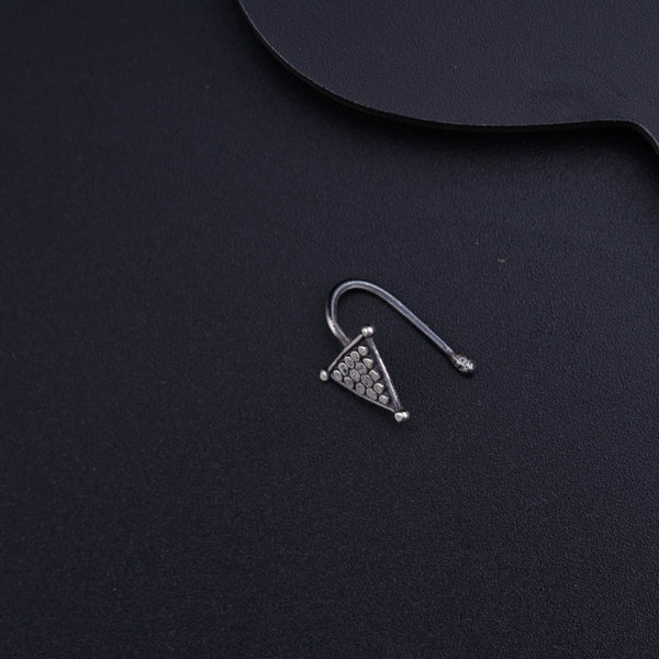 a pair of ear clips sitting on top of a black surface