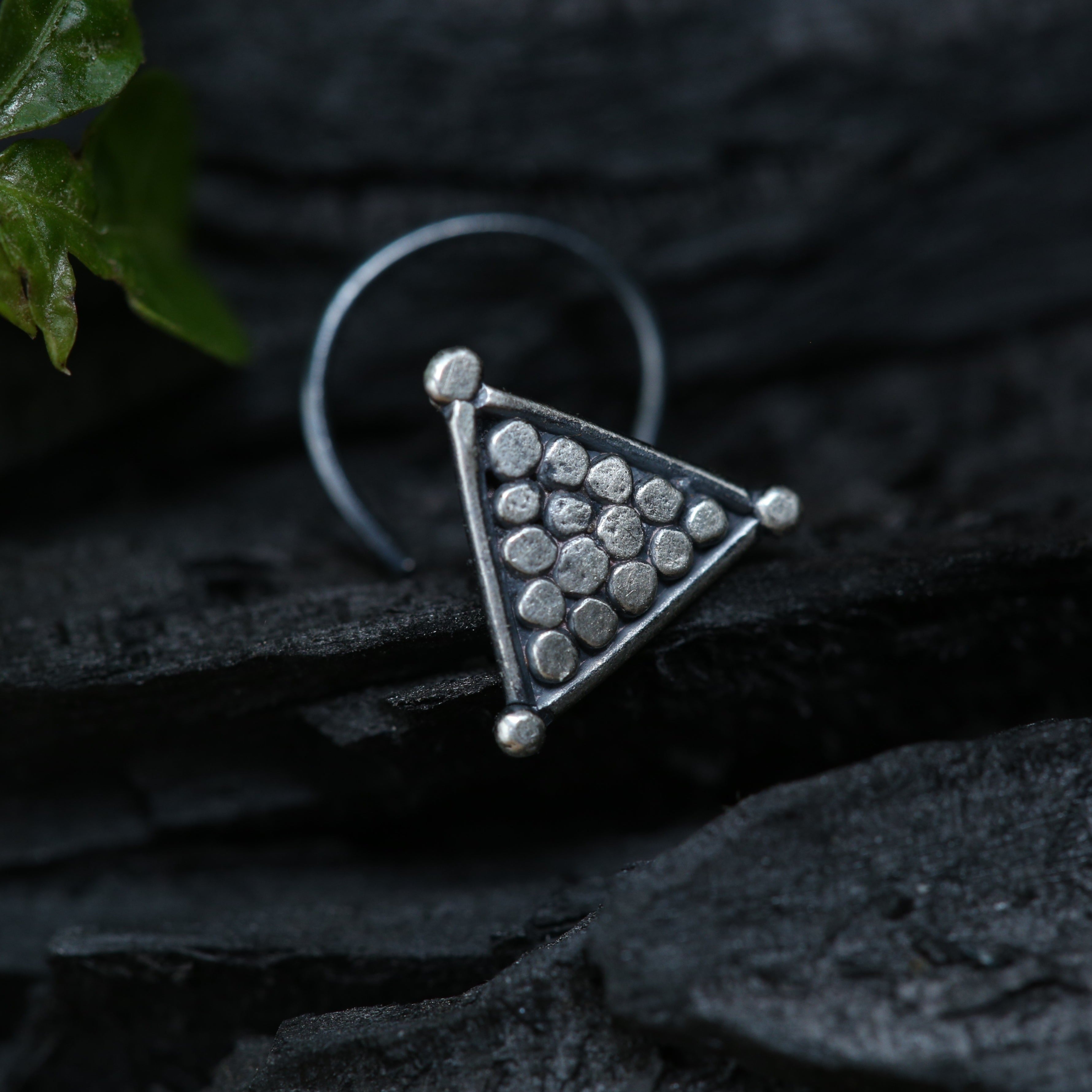 a silver ring with a triangle design on it