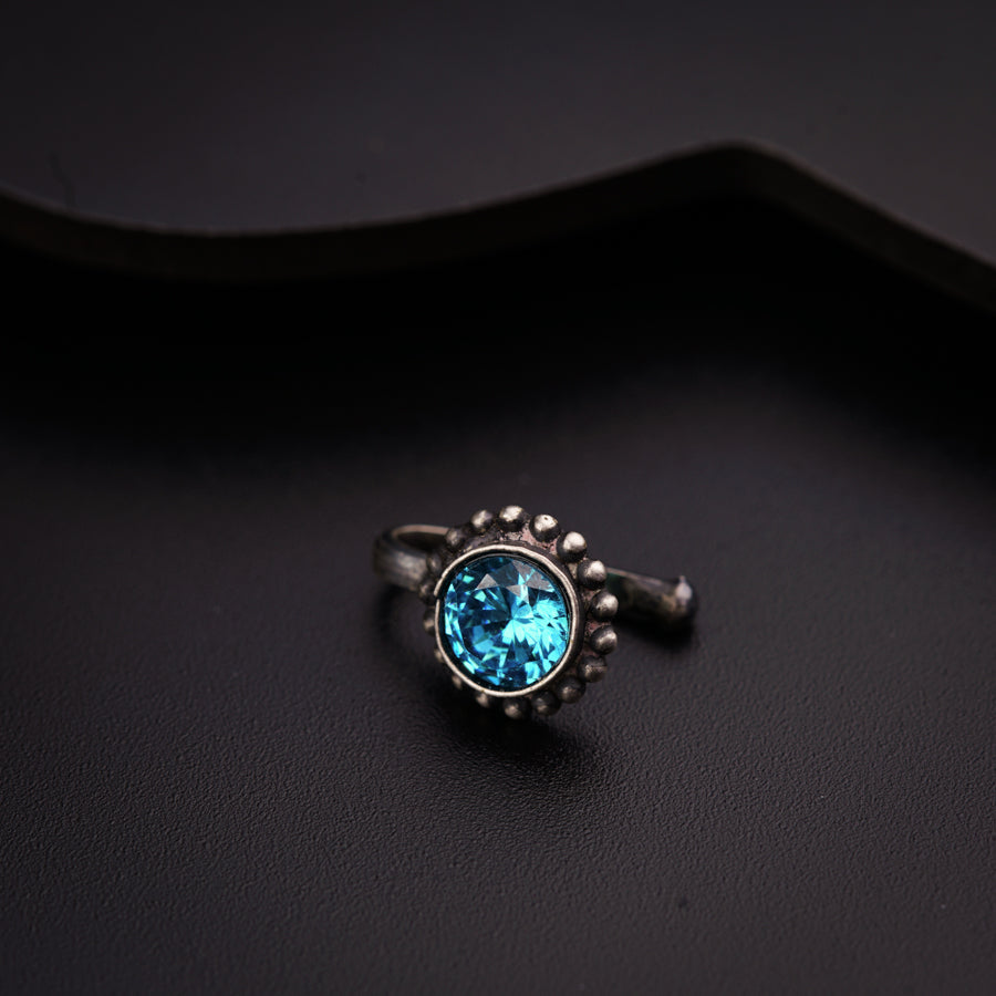 a close up of a ring with a blue stone