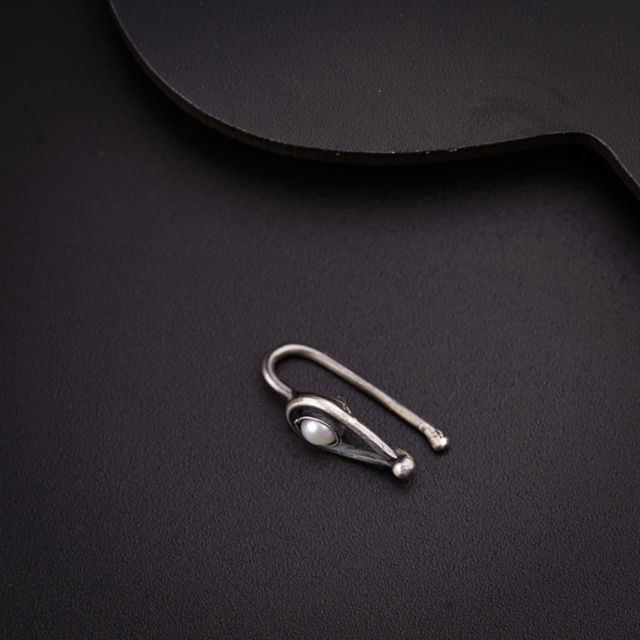 a pair of ear buds sitting on top of a black surface