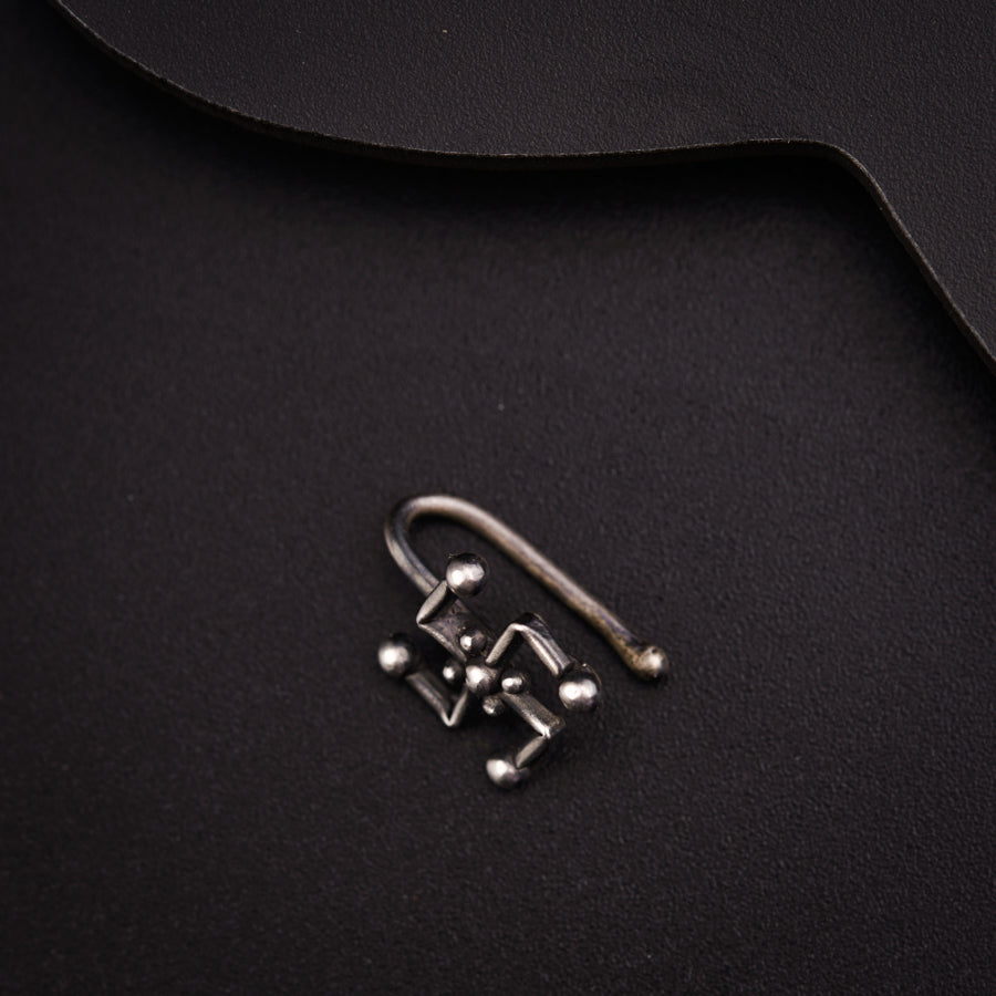 a pair of metal hooks on a black surface
