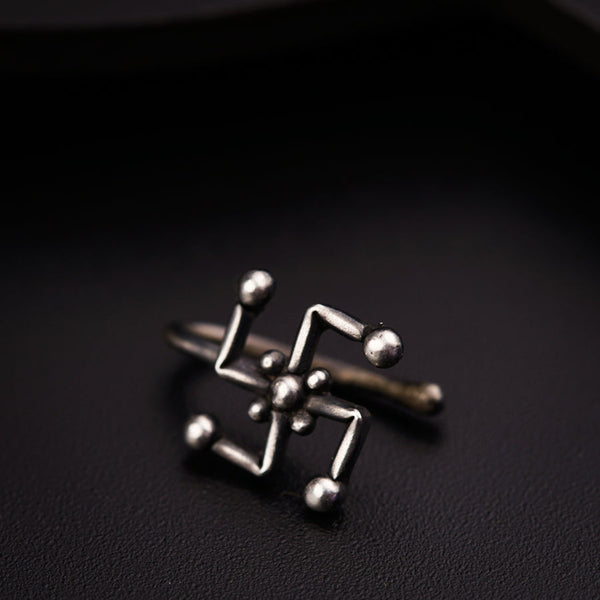 a pair of silver rings sitting on top of a black surface