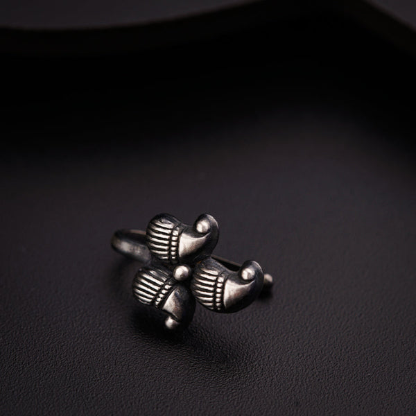 a silver ring sitting on top of a black surface