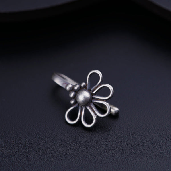 a silver ring with a flower on it