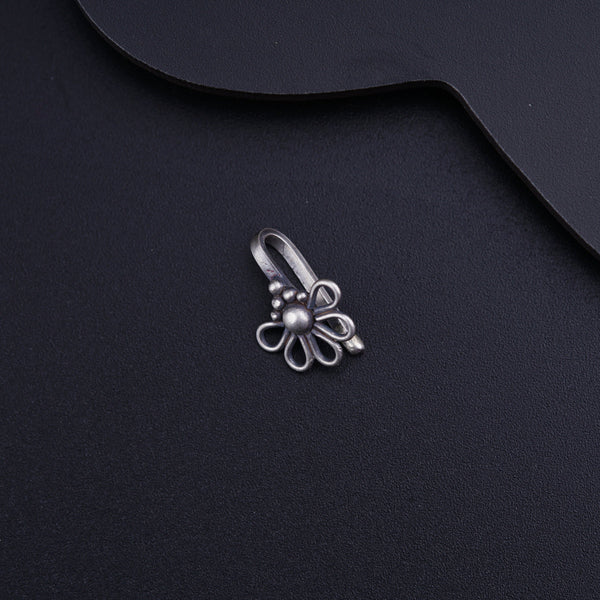 a metal object on a black surface